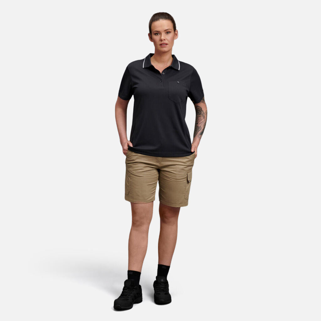 Person wearing Explorer Shield polo, khaki shorts, and black shoes with emblem.