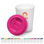 White reusable cup with a pink lid and several colorful lid options lined up in front.
