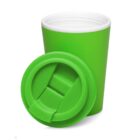 A green travel mug with a matching green lid resting beside it.