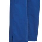Close-up of the lower legs of blue pants with small side slits at the hem.