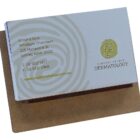 Business cards for Central Sydney Dermatology displayed on a brown holder.
