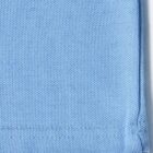 Close-up of light blue textured fabric with stitched hem on the bottom right corner.