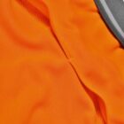 Close-up of an orange sports fabric with a seam and a gray waistband.