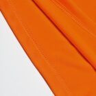 Close-up of orange fabric with visible stitching on a white background.
