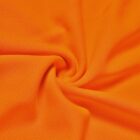 Bright orange fabric twisted into a spiral pattern, showing textured, woven material.