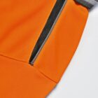 Close-up of an orange zippered pocket with gray fabric trim.