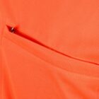 Close-up of an orange fabric pocket with a small zipper partially visible at the pocket opening.
