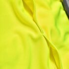 Close-up of yellow athletic fabric with a seam and mesh detail.