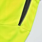 Close-up of a yellow fabric garment with a black zipper pocket.