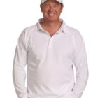 Smiling man in white sports attire and cap with hands in his pockets.