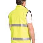 Person wearing a bright yellow high-visibility vest, shown from the back.