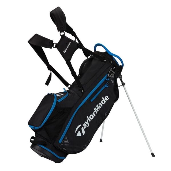 A black and blue TaylorMade golf bag with shoulder straps and two extended metal stand legs. The bag is shown in a standing position, displaying multiple compartments and the TaylorMade logo.