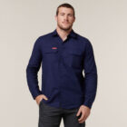 Man wearing Explorer Shield long-sleeve shirt in dark blue with dark pants, plain background.