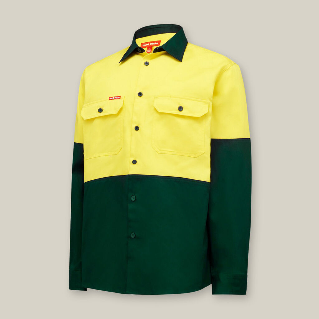 A long-sleeve button-up shirt resembles the vibrant colors of the Emz A5 Notebook, with a bright yellow top half and dark green bottom half. It has two yellow chest pockets with buttoned flaps, a dark green collar, all against a light gray background.