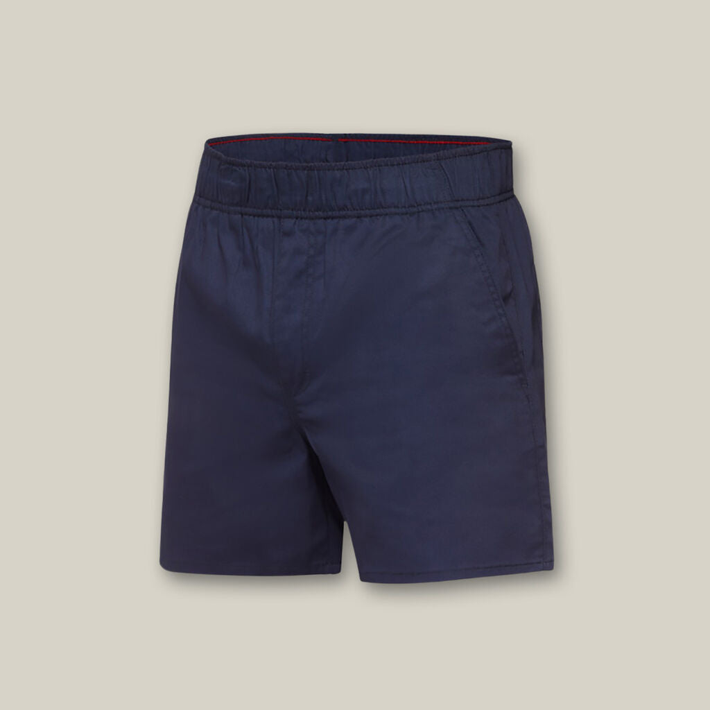 Explorer Shield navy blue shorts with elastic waistband and side pockets on beige background.