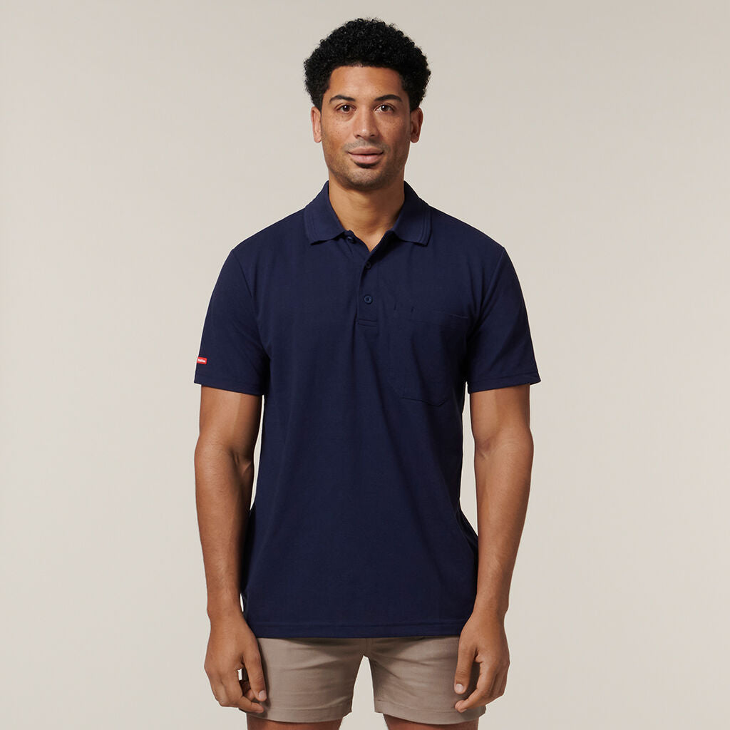 Man in a navy polo and tan shorts wears the Explorer Shield against a light background.