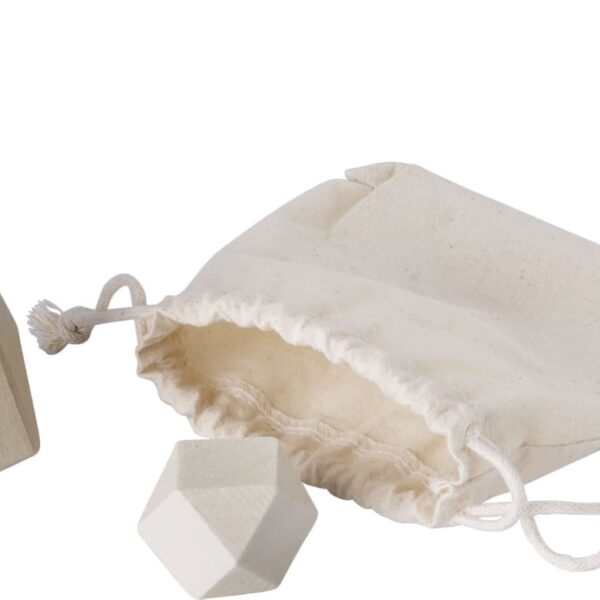 Wooden geometric blocks and a drawstring bag on a white background.