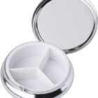 Round, silver pillbox with a mirror lid and three white compartments inside.