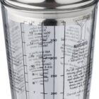 Cocktail shaker with measurement markings and recipe instructions on the glass.