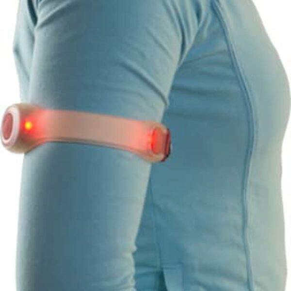 Person wearing a blue jacket with a glowing red armband on their upper arm.