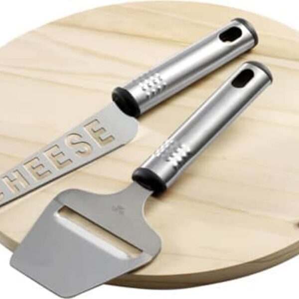 Cheese board with a cheese knife and slicer on a wooden surface.