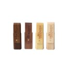 Four wooden USB drives with logos, in different shades from dark to light.