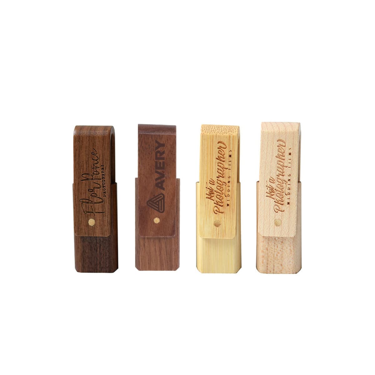 Four wooden USB drives with logos, in different shades from dark to light.