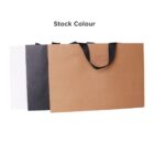Three paper shopping bags in white, black, and brown with black handles.
