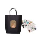Black gift bag with a bear design and colorful sheets of stickers.