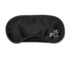 A black sleep mask with a gray trim, featuring the word Zija in white letters and a small green sprout graphic on the right side. The mask is centered on a white background.