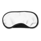 A white sleep mask with a black border placed on a white background.