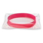A red silicone wristband is sealed in a clear plastic bag. The band is flat and circular, positioned diagonally in the packaging against a white background.