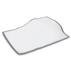 A white rectangular absorbent pad with gray trimmed edges, lying flat on a white surface, slightly wrinkled in appearance.