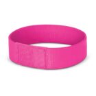 A bright pink wristband or exercise band made of fabric, forming a loop with a visible seam where the ends are attached. It is placed against a plain white background.