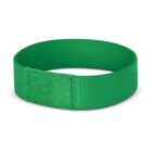 Green fabric wristband with a rectangular patch detail, forming a closed loop. The texture is slightly visible, giving a soft appearance. The background is plain white.