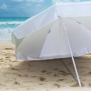 Custom beach umbrellas dot the sandy shore by the ocean under a clear blue sky.