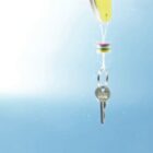 A key attached to a yellow floating device submerged in water.