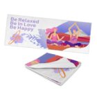 Illustrated yoga mat featuring two people meditating outdoors beneath a purple sky with mountains. Text reads, Be Relaxed Be In Love Be Happy. A folded view of the mat is shown in the corner.