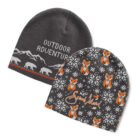 Two knitted beanies: one gray with white mountains, bears, and Outdoor Adventure text; the other dark gray with orange and white foxes amid white patterns, and cursive Send Island text.