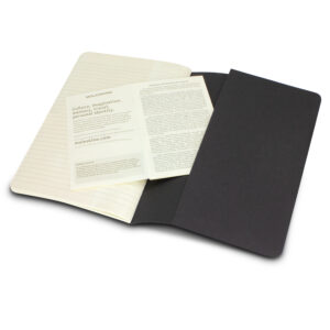 Lined page black notebook with time management tips inside.