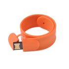 Orange USB bracelet with open connector, coiled in a circle.