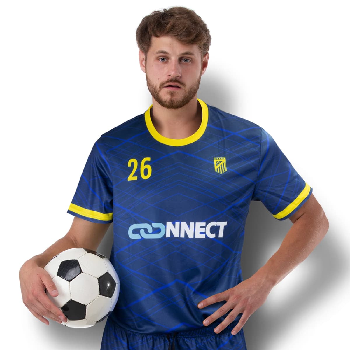 A soccer player in a blue and yellow uniform with number 26 stands against a white background, holding a soccer ball under one arm. The jersey has a Connect logo on it. The player has short brown hair and is looking at the camera.