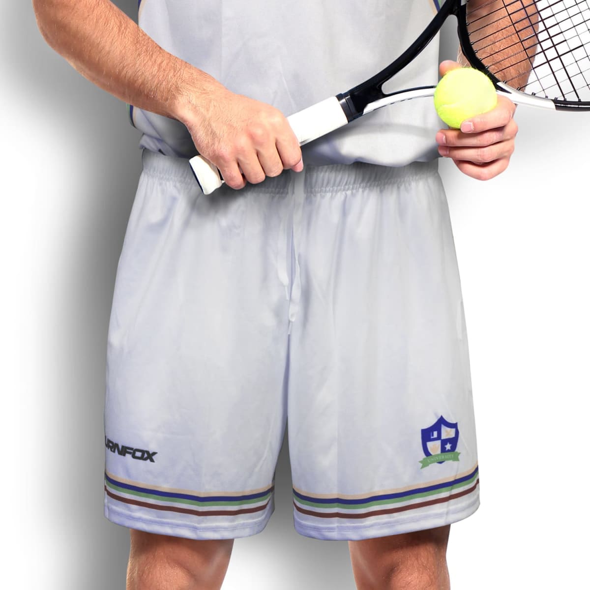 A person in a light-colored sports outfit holds a tennis racket and a yellow tennis ball. The logo on the shorts includes a shield design. The background is a plain light shade.