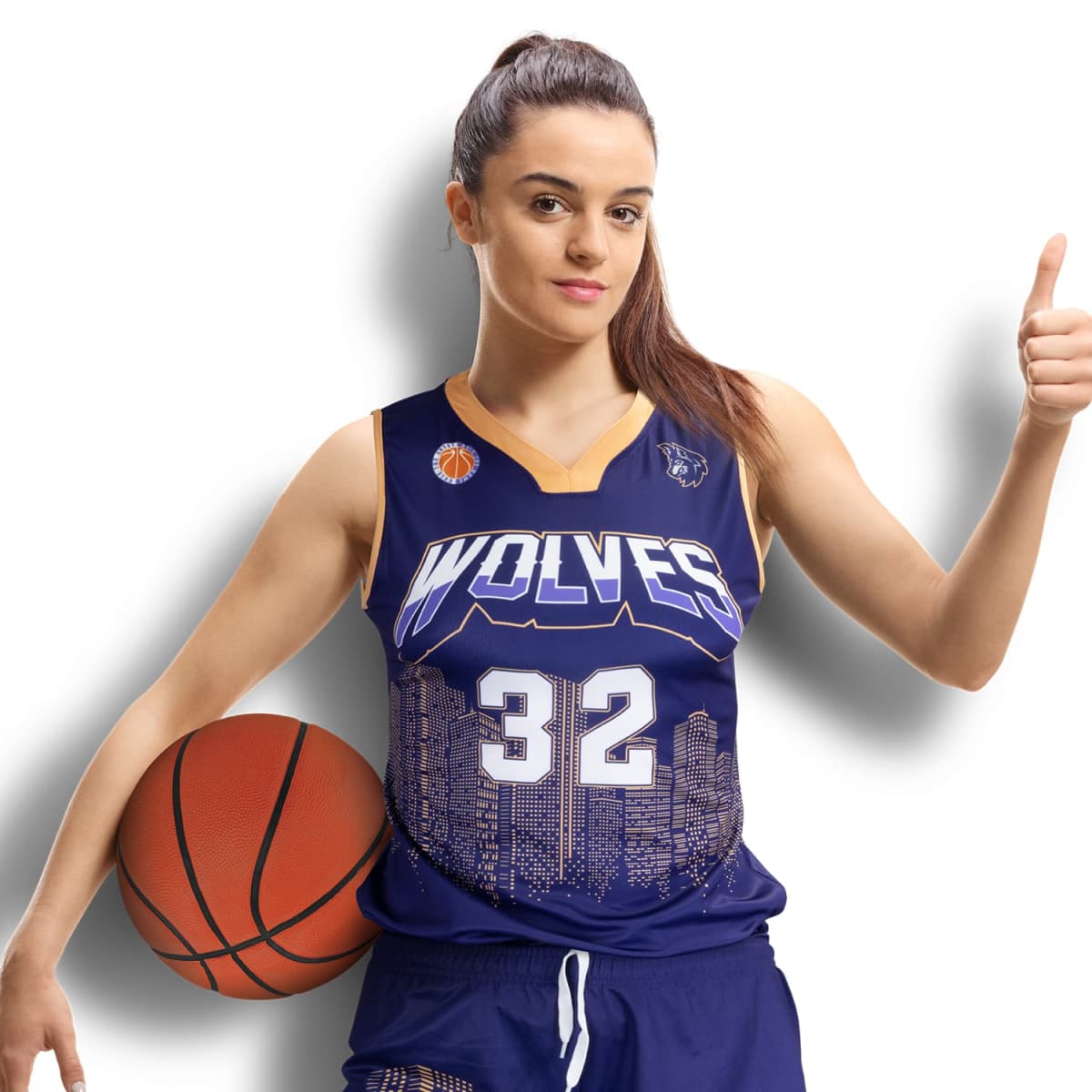 A woman in a blue basketball uniform with Wolves and the number 32 printed on it stands holding a basketball in her left hand. She gives a thumbs-up with her right hand against a white background.
