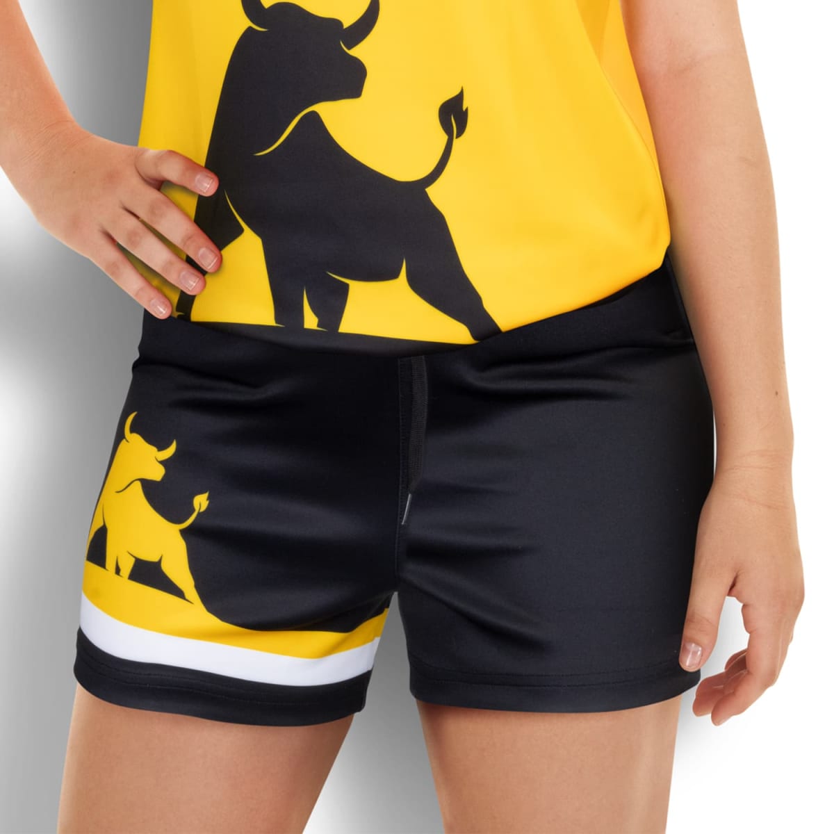 Person wearing a yellow shirt with a black bull graphic and black shorts featuring a similar bull design with yellow and white stripes. Hand on hip, standing against a white background.
