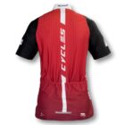 Red and black cycling jersey with vertical stripes, featuring the word CYCLES in white on the back. The jersey has a white stripe down the center and a few sponsor logos on the sleeves and lower back.
