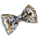 A bow tie with a pattern featuring colorful cartoon ghost faces, primarily in shades of white, yellow, and black, on a dark background.