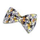 A bow tie featuring a colorful pattern of cartoon ghosts and paws in yellow, white, and orange on a black background. The bow is neatly tied and has a playful, festive appearance.