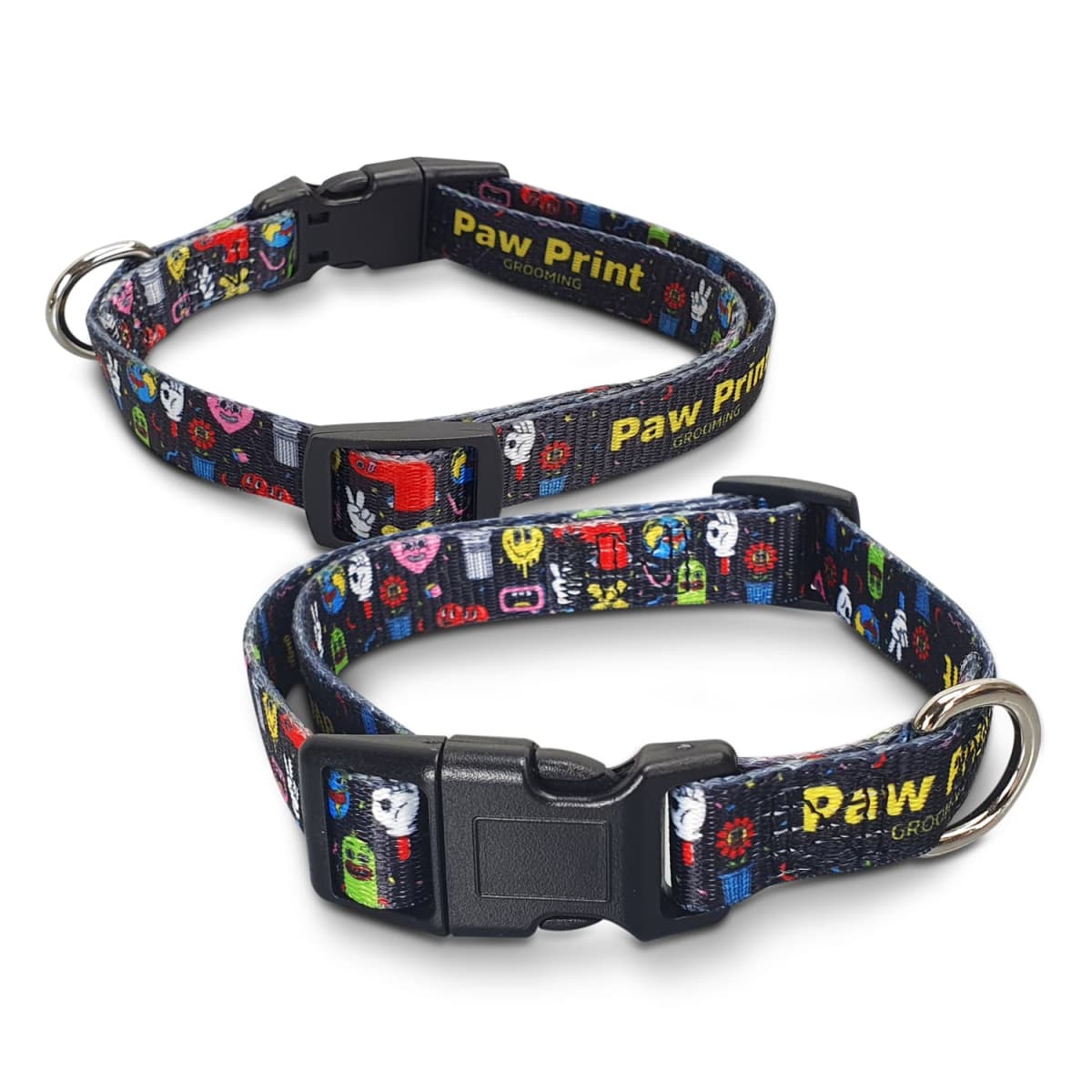 Two colorful dog collars are shown, featuring playful cartoon designs. They have black plastic clasps and metal rings for attaching a leash. The collars display the text Paw Print in yellow.