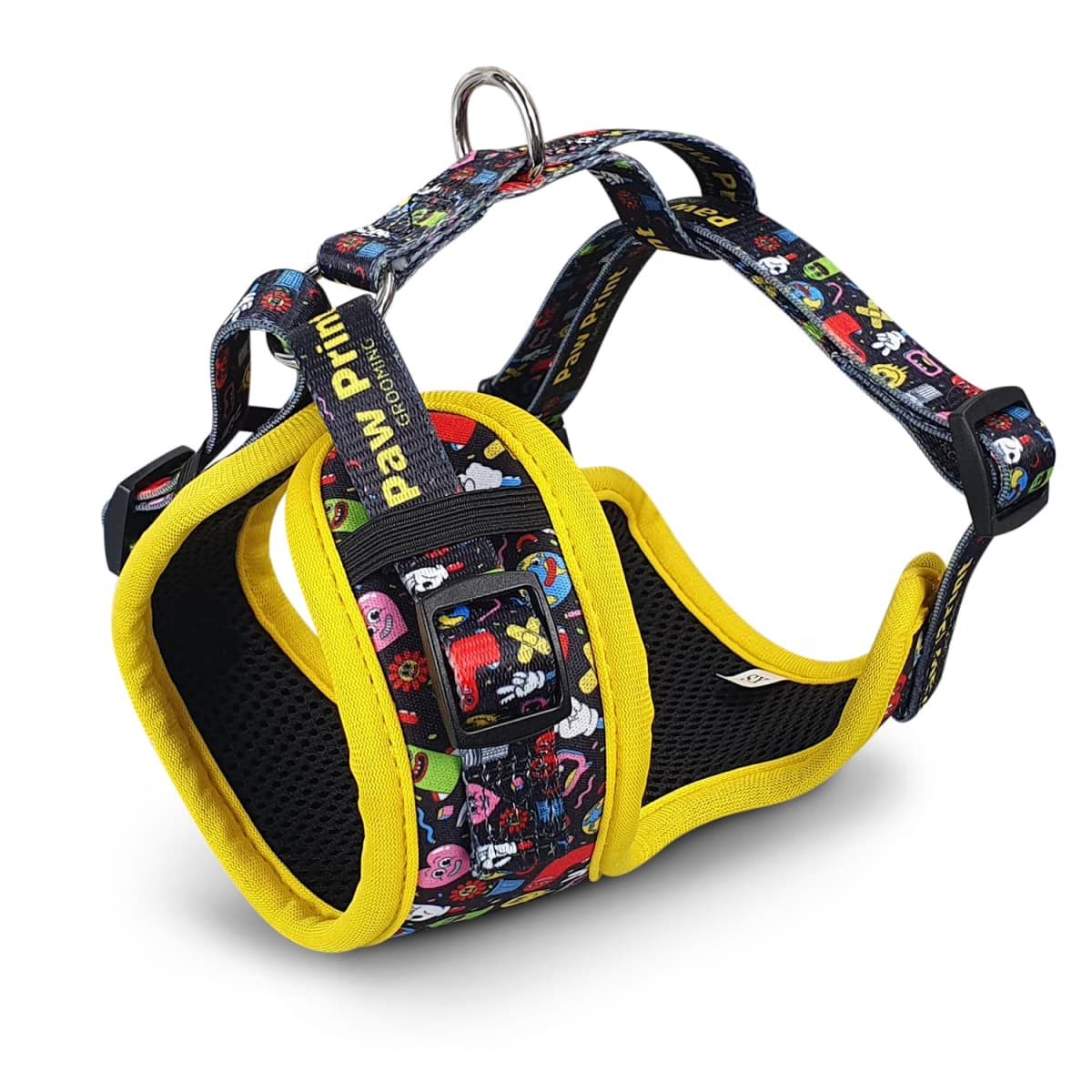 A colorful dog harness with a black base and yellow trim is shown. It features a playful pattern with various cartoon designs. The harness includes adjustable straps and a metal ring for a leash attachment.